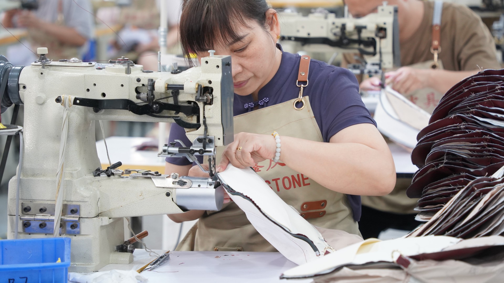 Close-up of sewing machine stitching backpack seams